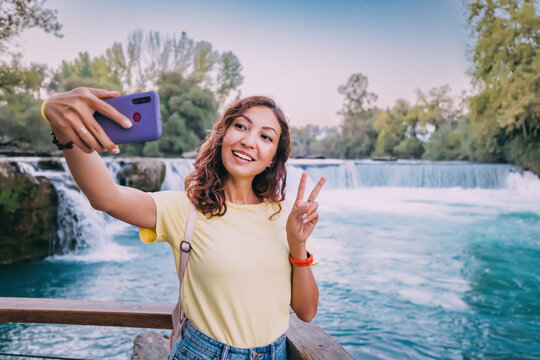 Travel blogger takes high-quality and vivid photos on the camera of his new expensive smartphone of the famous Manavgat waterfall in Turkey