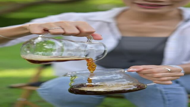 Person holding a glass of coffee