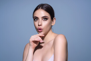 Close up photo of impressed woman isolated over studio background. Portrait of an excited young girl looking in excitement. Young woman shocked with surprise expression, amazed and excited face.