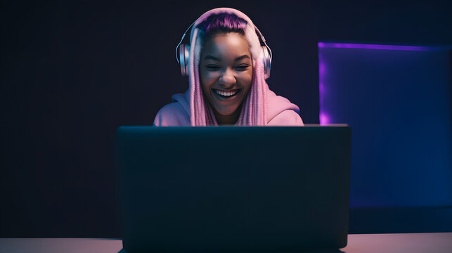 Cheerful female gamer winning an online game on a laptop