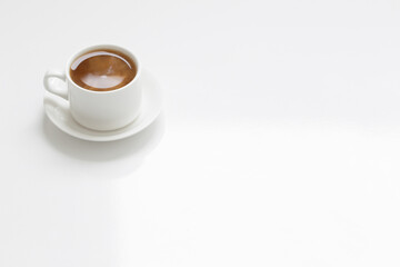 Fototapeta na wymiar white cup of coffee on white table