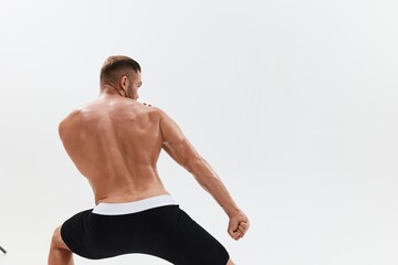 Fototapeta premium Man athletic body bodybuilder in briefs with naked torso abs full-length in the background, fitness classes. Advertising, sports, active lifestyle, competition, challenge concept.