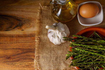 top view of wild asparagus in earthenware casserole dish
