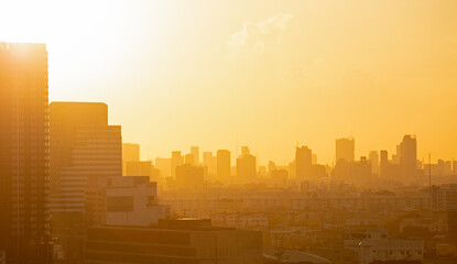 Sunrise scenery of a bangkok, Thailand. Skyline view of cityscape with sunlight and flare in warm light color tone.