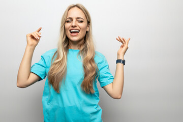 cheerful girl getting high on white studio background