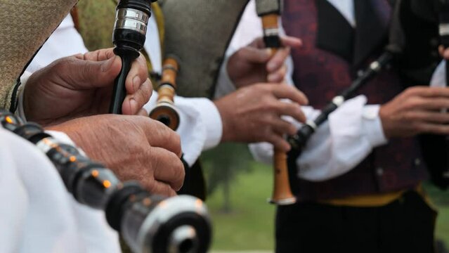 Detail of hands playing the traditional Galician bagpipe in a folk group in slowmotion