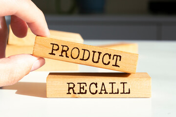 Wooden blocks with words 'PRODUCT RECALL'.