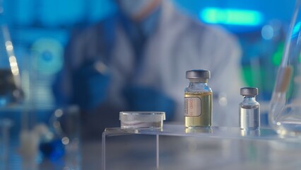 Glass vials with SARS-CoV-2 virus vaccine on a blurred background with a doctor in a white coat. Bottles with transparent liquid and light reflection. The concept of vaccination. Close up.