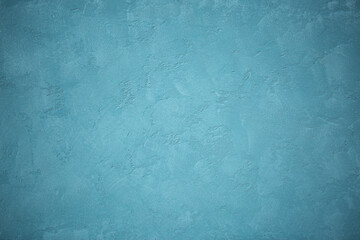 Blue background of decorative plaster with abstract spots. Unusual texture of this wall with beautiful patterns, creative surface background. Finishing coating for building cladding.