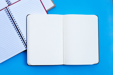 Notebooks on blue background. Top view