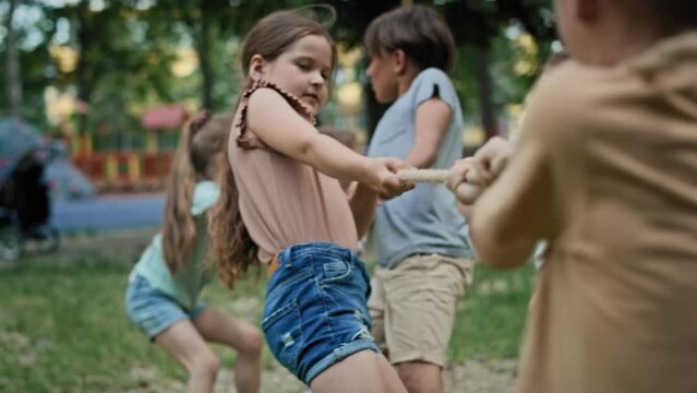 Group of caucasian kids playing tug of war. Shot with RED helium camera in 8K.  