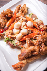 chinese and western mixed seafood combination cold platter with deep fried soft shell crab scallop salad on wood table asian banquet halal menu
