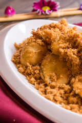 deep fried crispy eggplant vegetable and chicken floss with pepper mayonnaise sauce in white plate on red cloth wood table asian halal banquet appetiser snack menu 