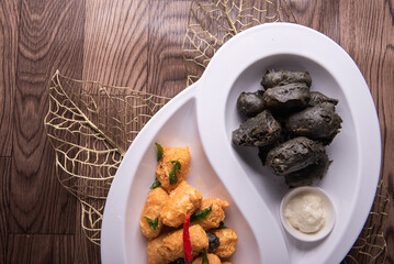 dou style deep fried crispy seafood beancurd black and white tofu in salted egg yolk sauce and mayonnaise sauce on wood table asian halal banquet appetiser snack salad menu 