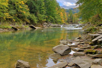 Autumn landscape of a river in a wooded area.