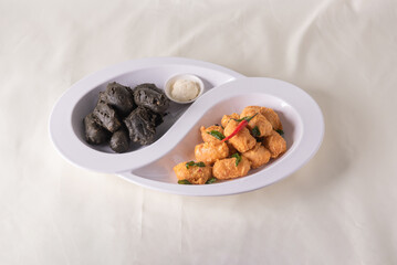 dou style deep fried crispy seafood beancurd black and white tofu in salted egg yolk sauce and mayonnaise sauce on wood table asian halal banquet appetiser snack salad menu 