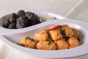 dou style deep fried crispy seafood beancurd black and white tofu in salted egg yolk sauce and mayonnaise sauce on wood table asian halal banquet appetiser snack salad menu 