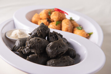 dou style deep fried crispy seafood beancurd black and white tofu in salted egg yolk sauce and mayonnaise sauce on wood table asian halal banquet appetiser snack salad menu 