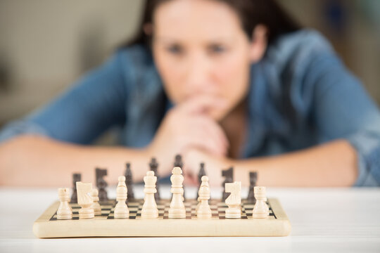 woman studying the next chess move