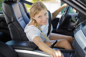Fototapeta na wymiar young happy female in car