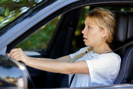 Frustrated Young Woman Driving Her Car