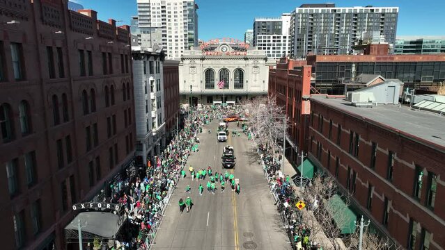 Rooftop view of Denver's St. Patrick's Day parade with green shirts everywhere.