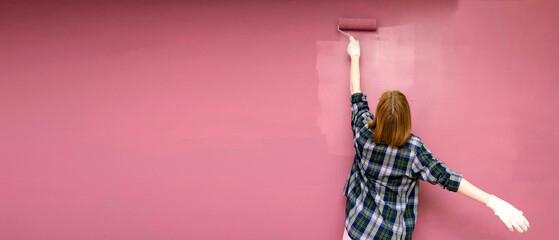 Redecorating. Painting walls with paint-roller