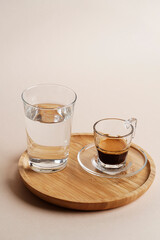Coffee cup and glass of water on a wooden tray