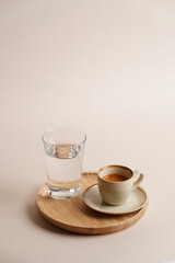 Coffee cup and glass of water on a wooden tray