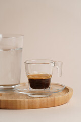 Coffee cup and glass of water on a wooden tray