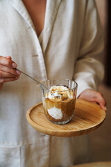 Woman hands holding affogato coffee and ice cream