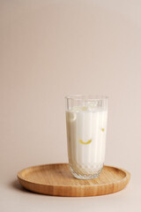 Iced milkshake cocktail glass on pastel background