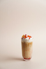 Milkshake cocktail glass with syrup, close-up