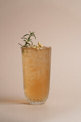 Refreshing cocktail with rosemary on light background