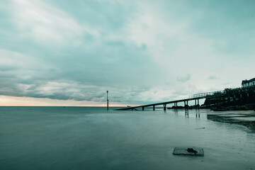 view of a boat jetty leading out to sea on a stormy day