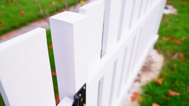 Stylish new white wooden fence on a country estate, smooth camera movement