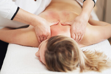 Obraz na płótnie Canvas Woman having back body massage in studio