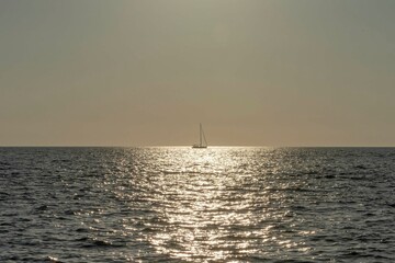 Nice sunset with a boat in sunlight on the sea on Mali Lošinj in Croatia