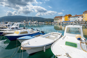 Fototapeta na wymiar Cres square with boats on the sea and houses during summer, Croatia