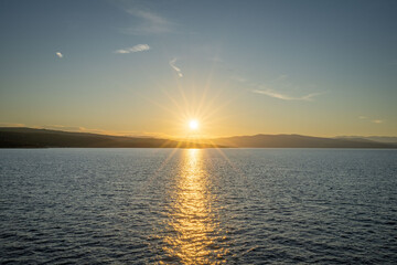 Nice sunrise with shining sun with rays on Krk in Croatia