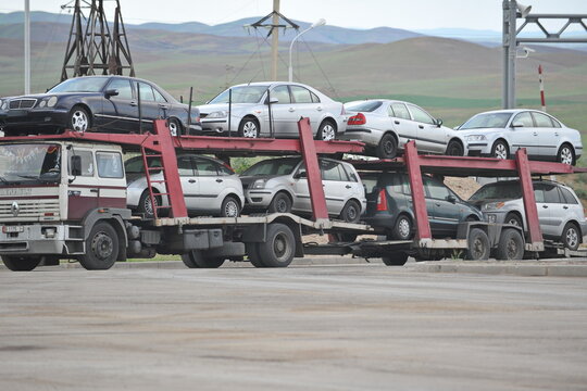 Almaty region / Kazakhstan - 05.25.2012 : A truck with several cars for sale. Customs post at the border.