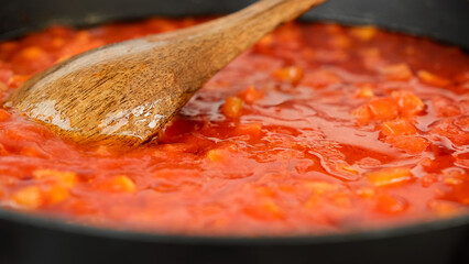 Tomato sauce boiling in a pan. Cooking tomato sauce for pizza or pasta. Traditional Italian cuisine