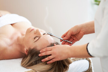 Obraz na płótnie Canvas Picture of moxibustion roller treatment op woman face
