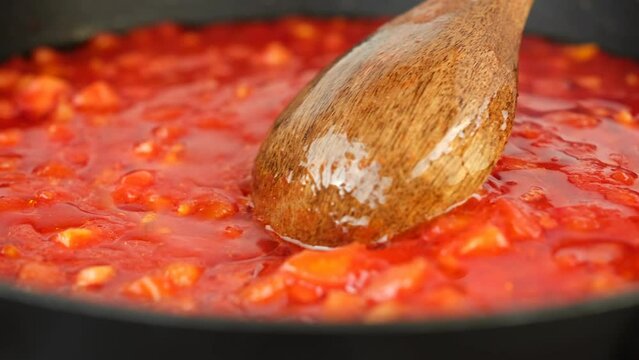 Tomato sauce boiling in a pan. Cooking tomato sauce for pizza or pasta. Traditional Italian cuisine