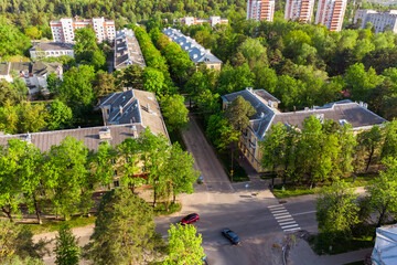 Aerial view of mid-rise urban landscape surrounded by green trees