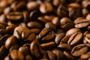 Roasted coffee beans background macro close-up, top view