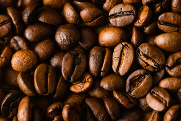 Roasted coffee beans background macro close-up, top view