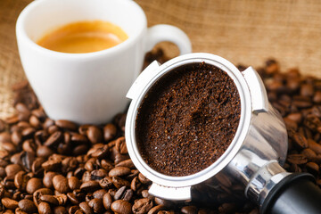 Spent or used coffee grounds with holder and a cup of freshly brewed coffee
