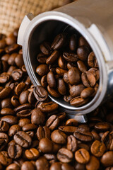 Roasted espresso coffee beans in metal holder
