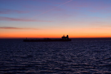 ship on horizon in the dark sunset